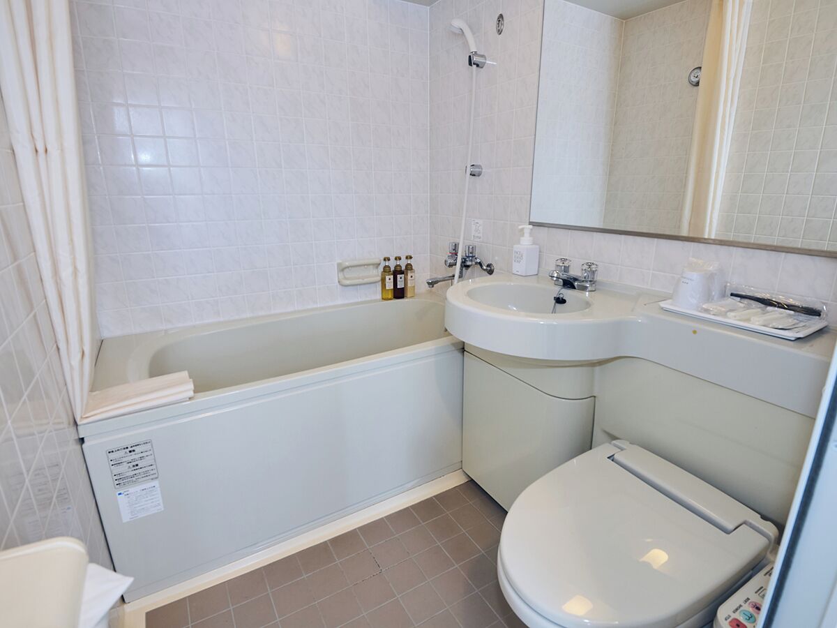 A bathroom with a bathtub, a sink, and a toilet.