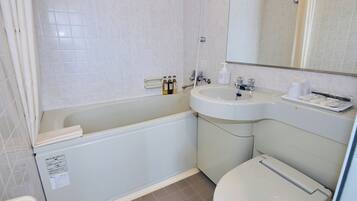 A bathroom with a bathtub, a sink, and a toilet.