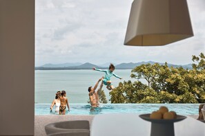 A poolside view with a clear sky, mountains in the background, and a lamp in the foreground. - COMO Point Yamu, Phuket (Pa Klok)