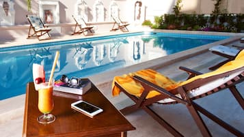 Seasonal outdoor pool, open 10:00 AM to 9:00 PM, pool umbrellas