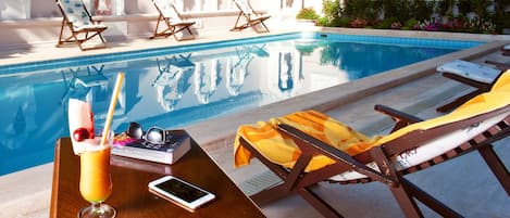 Piscine extérieure, parasols de plage, chaises longues