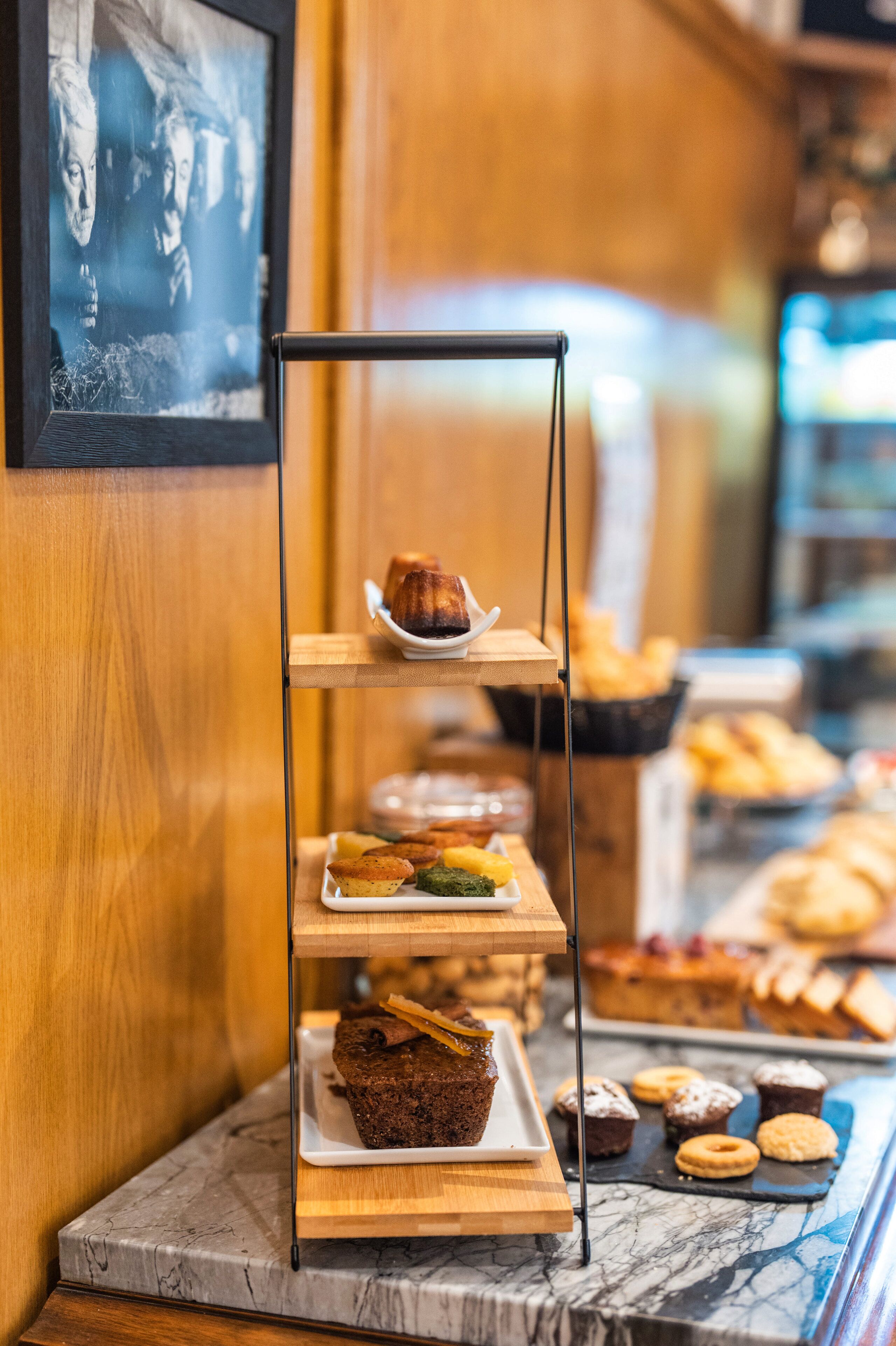 A bakery display with various baked goods on a marble countertop.