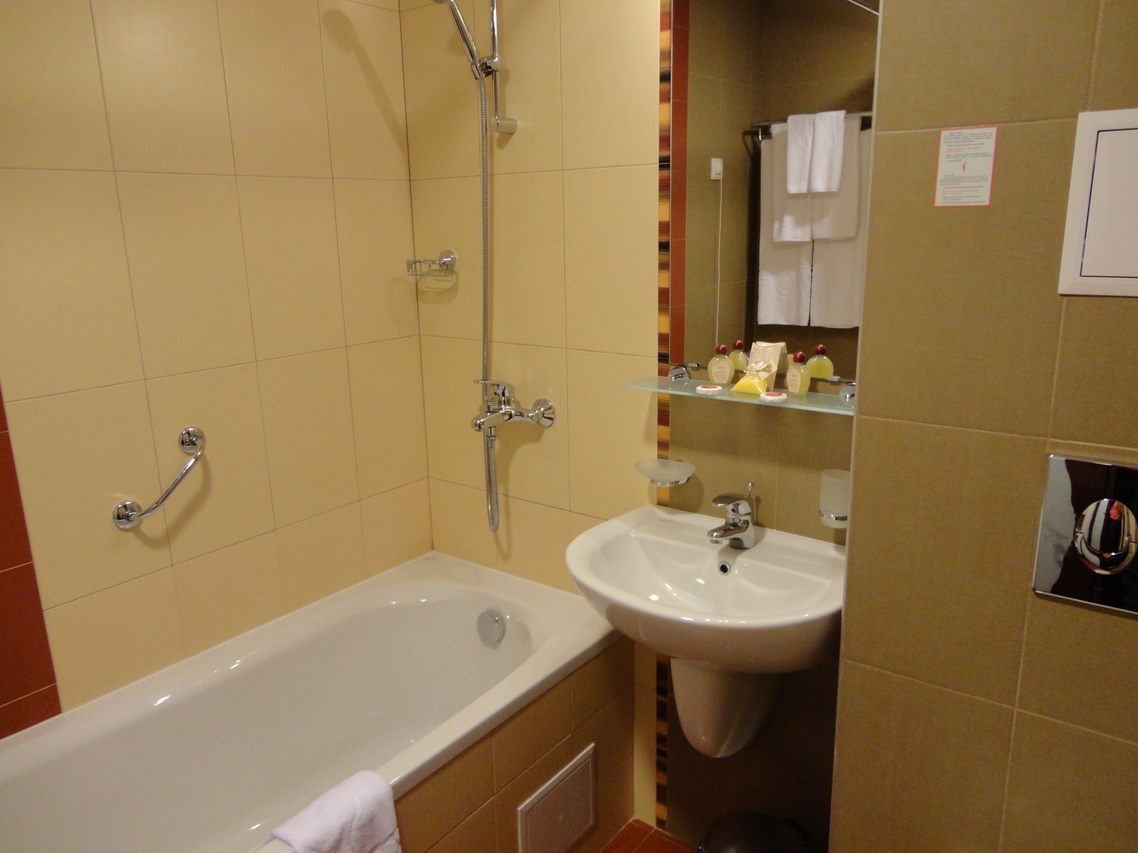 A bathroom with a bathtub, a sink, and a shower.