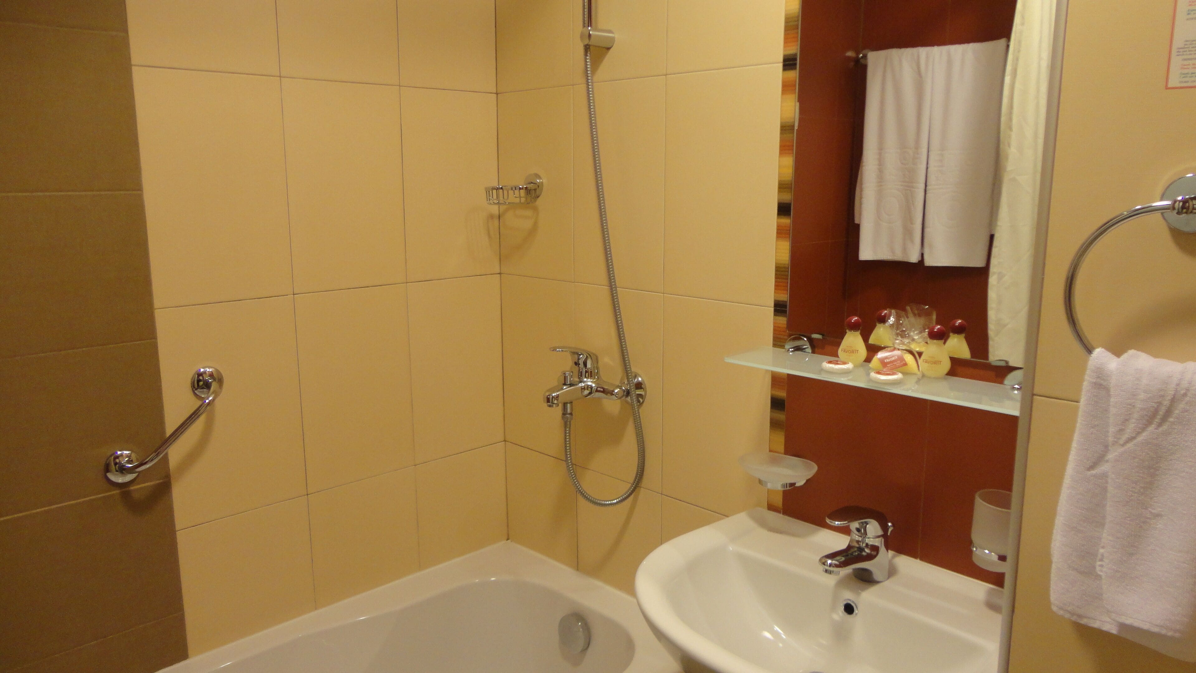 A bathroom with a bathtub, a sink, and a shower.
