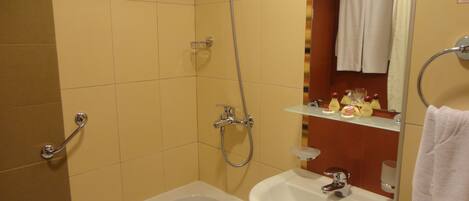 A bathroom with a bathtub, a sink, and a shower.