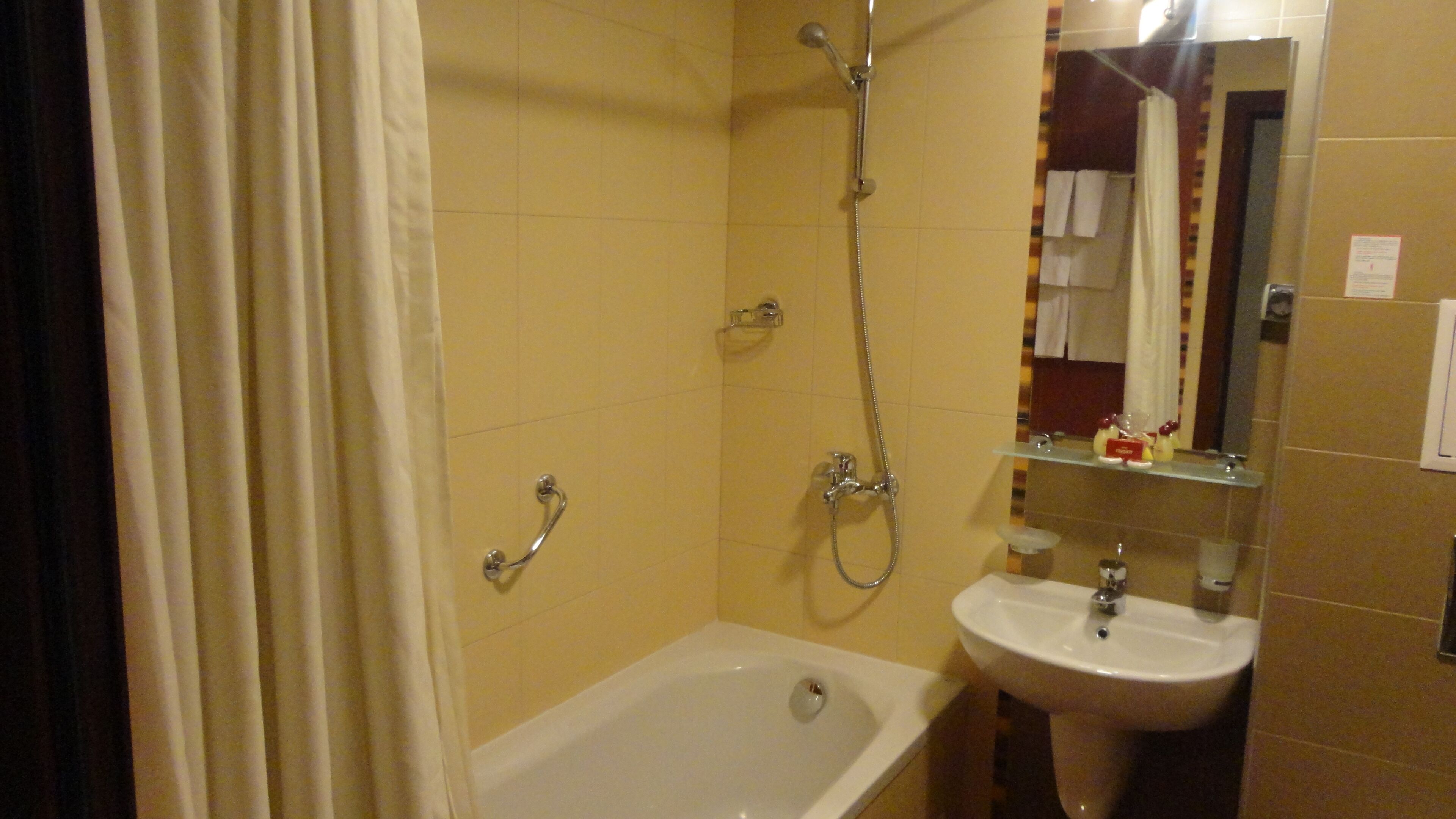 Un baño con bañera, lavabo y ducha.