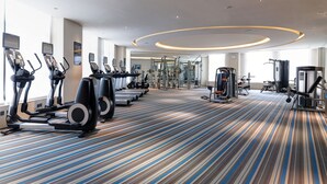 A gym with treadmills, elliptical machines, and weight equipment. - Aloft Dalian (Dalian)