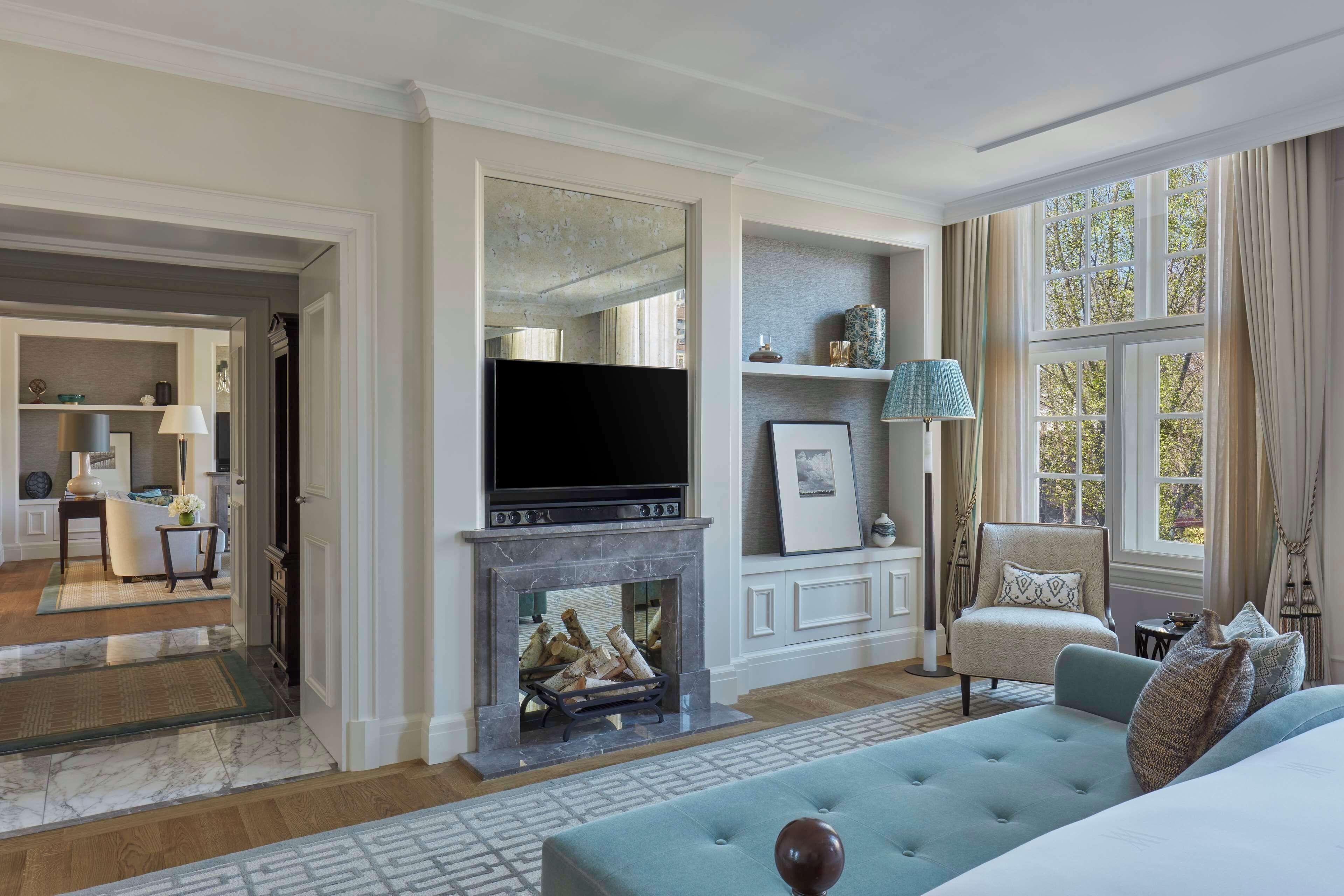 A spacious living room with a fireplace, a television, and a comfortable seating area.