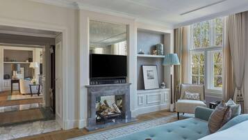 A spacious living room with a fireplace, a television, and a comfortable seating area.
