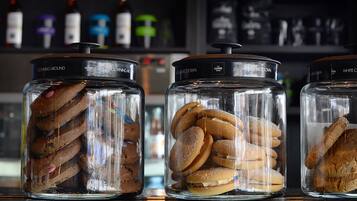 Three glass jars with lids, each containing different types of cookies.