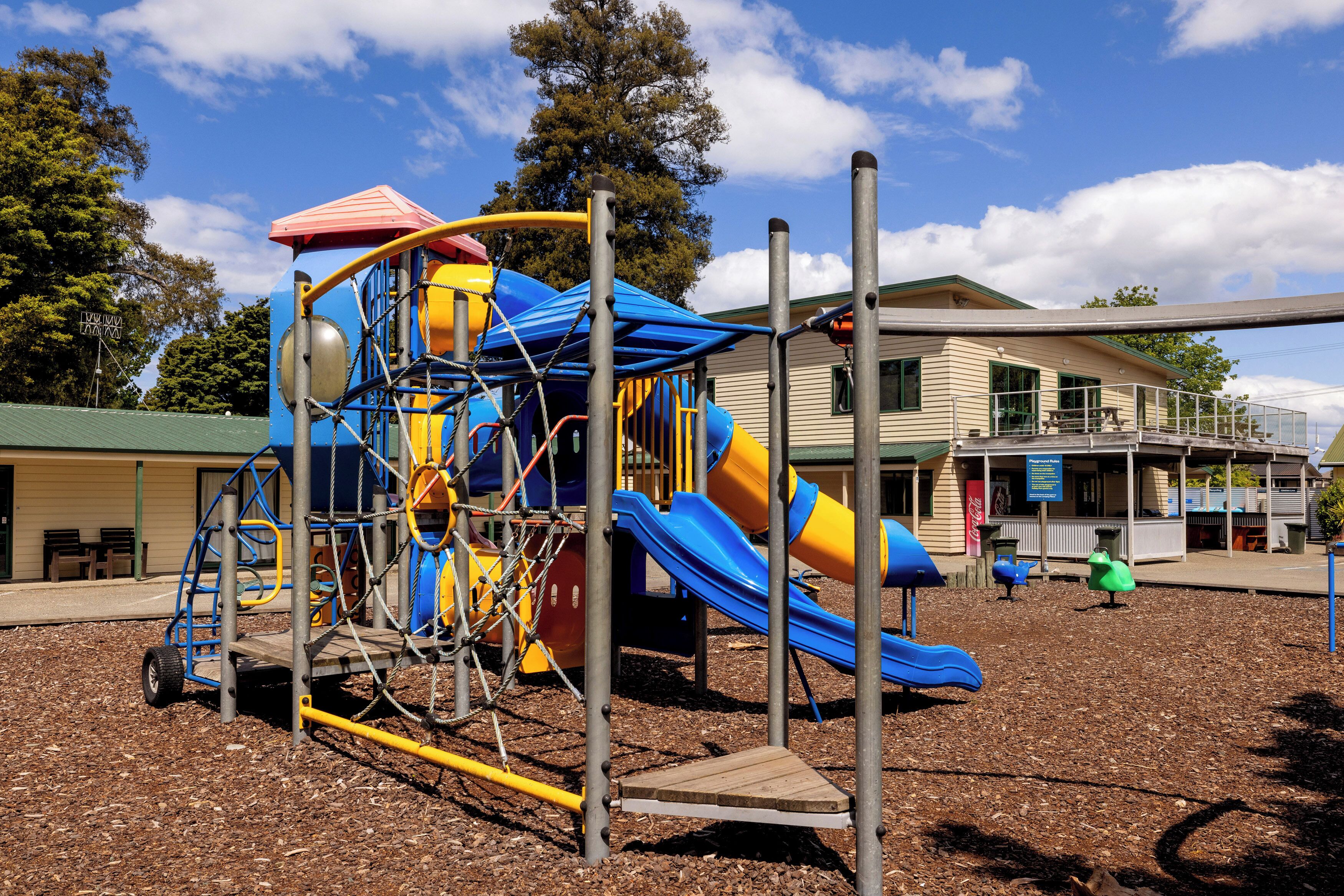 Un parque infantil con tobogán y estructuras para escalar.