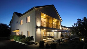 A two-story building with a balcony, a reception area, and outdoor seating. - Saxton Lodge (Nelson)