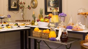 A buffet table with various food items, including fruits, pastries, and beverages. - Elegance Residence (Istanbul)