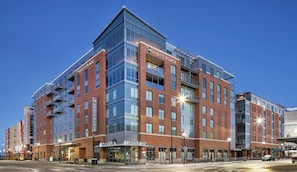 A multi-story hotel with a prominent 'Hyatt Place' sign, a 'Pinnacle Bank' branch, and a modern architectural design.