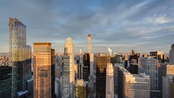 A cityscape with various high-rise buildings, including a distinctive dome-shaped structure and a tall, cylindrical building.