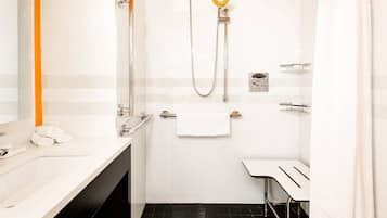 A modern bathroom with a shower, a toilet, and a sink.