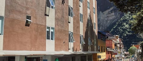 A hotel with a modern architectural design, located near a railway station.