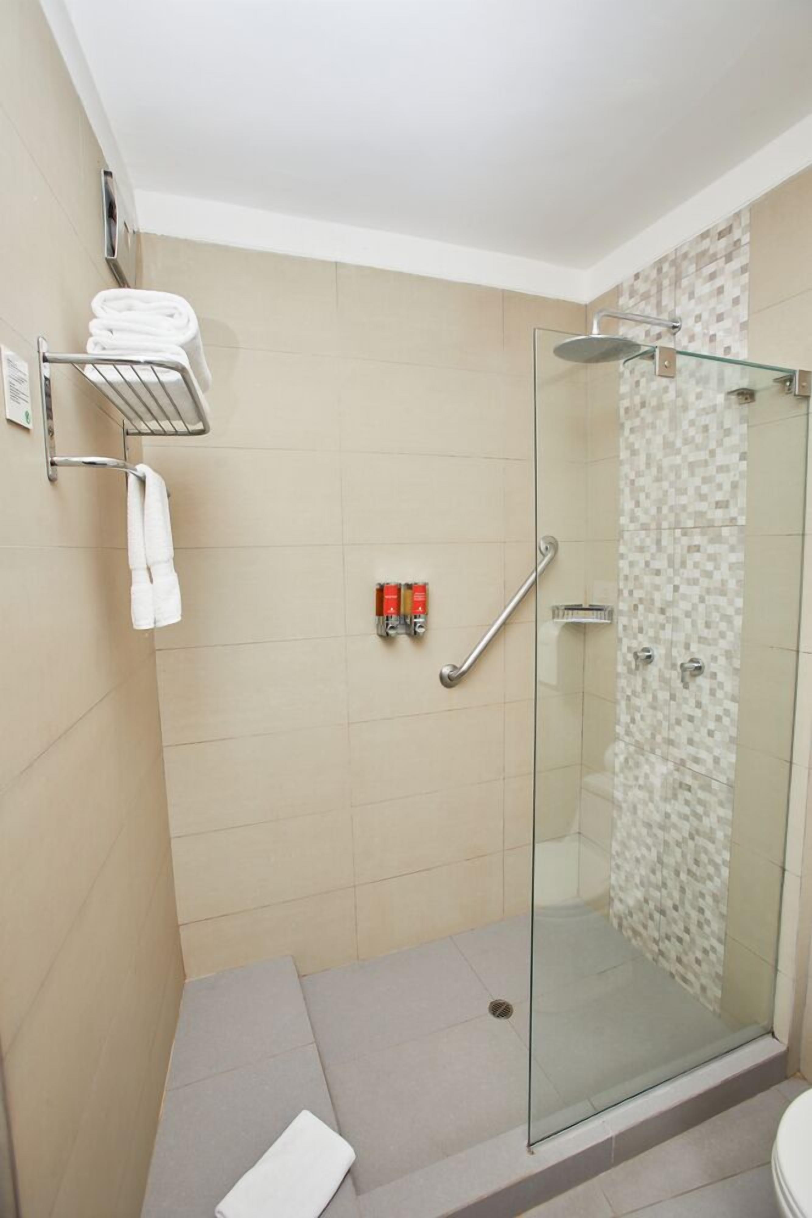 junior room, 1 king bed | bathroom | shower, free toiletries, hair dryer, towels