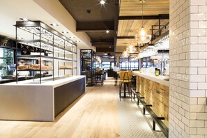 A modern bar area with a long counter, wooden accents, and hanging pendant lights. - Strandhotel Vigilante (Makkum)