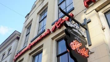 A hotel with a large, ornate sign featuring the name "Hotel Imperial" in red neon lights.