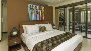 Una habitación de hotel moderna con una cama grande, una mesita de noche, un adorno en la pared y un ventanal corredero que da a un balcón.