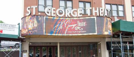 The exterior of St. George Theatre with a marquee advertising the "St. George Theatre" and "A New Profit Organization."