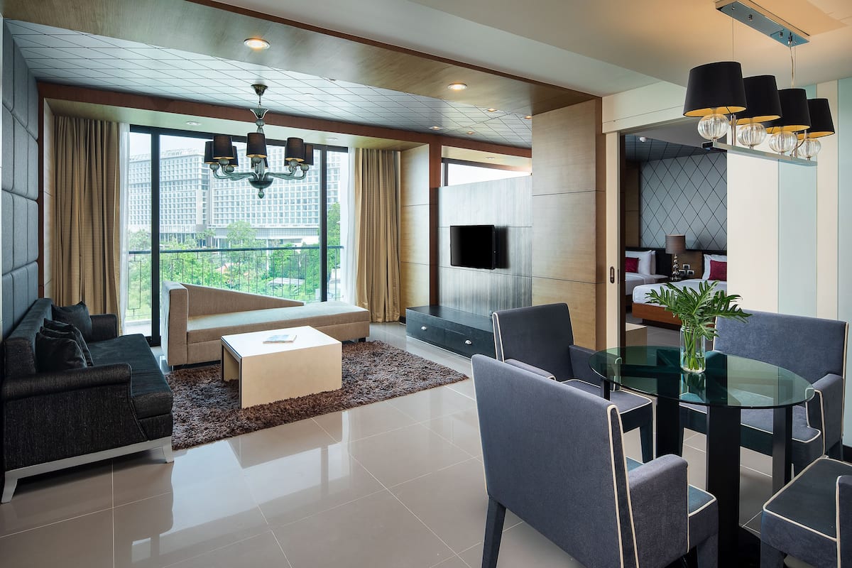 A modern living room with a sofa, coffee table, and dining area.