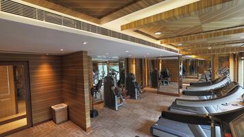 A gym with treadmills, weight machines, and mirrors.