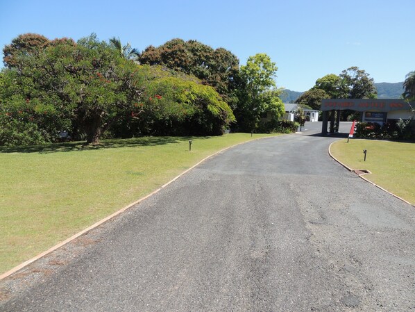 A road leading to a building with a sign that reads "Hotel."