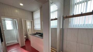 A bathroom with a shower, toilet, and sink.