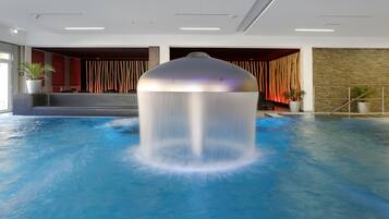 Relax by the tranquil pool surrounded by a modern design and lush greenery.
