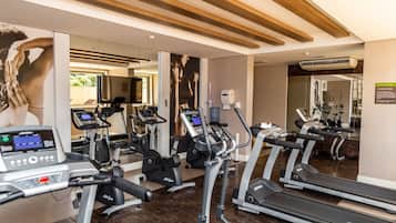 A gym with treadmills, elliptical machines, and a weight machine.