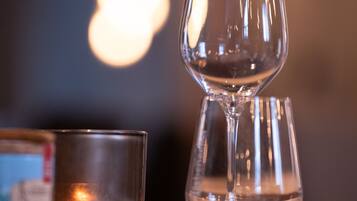 A glass of water on a table with a blurred background of lights.