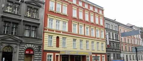 A multi-story building with a prominent sign reading "HOTEL CITY CENTRAL".