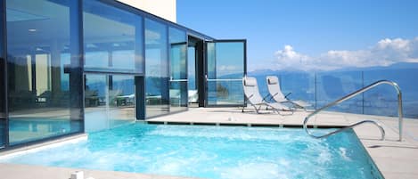 Indoor pool, outdoor pool, pool umbrellas, pool loungers