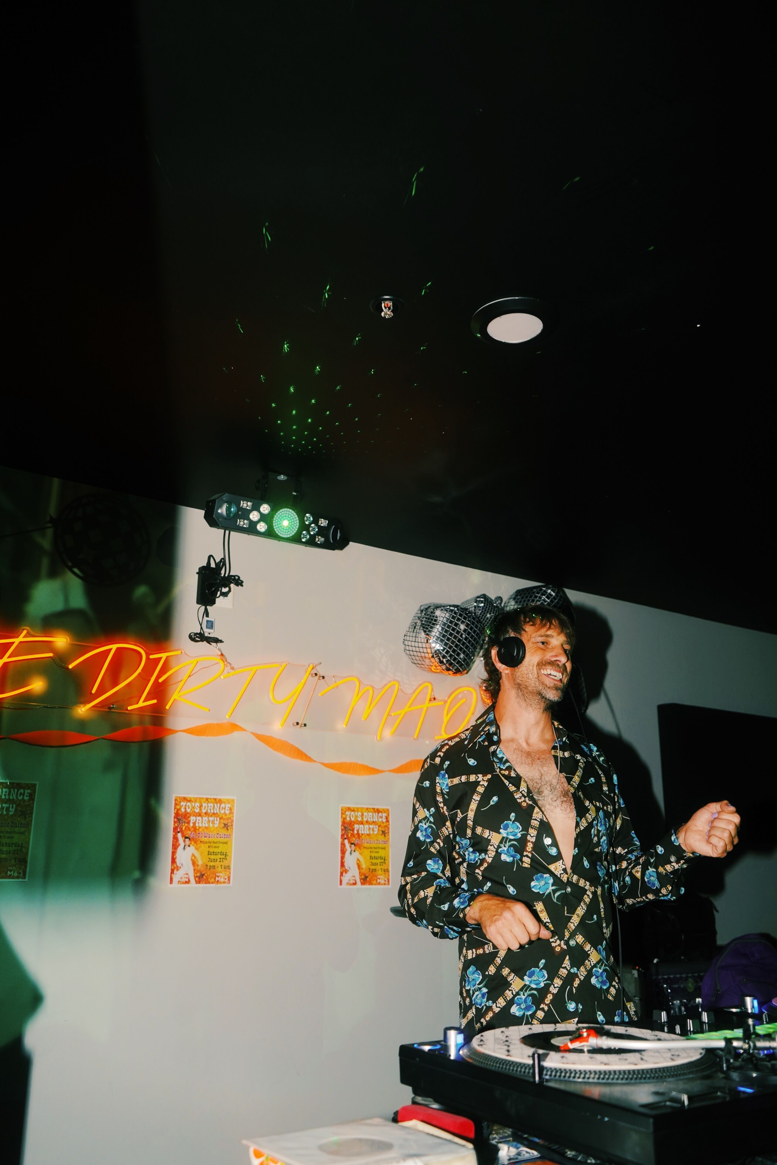 A DJ booth with a neon sign reading 'EDDY PARTY' and a disco ball.
