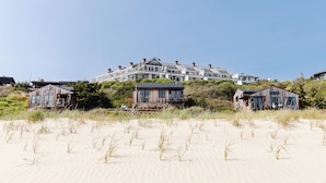 A beachfront property with multiple houses, including a large house with a balcony and smaller houses with wooden facades. - Gurney's Montauk Resort & Seawater Spa (Montauk)
