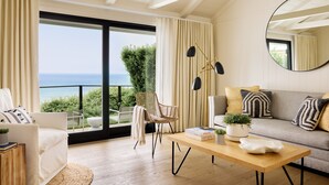 A modern living room with a sofa, a chair, a coffee table, and a view of the sea. - Gurney's Montauk Resort & Seawater Spa (Montauk)
