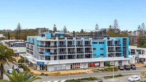 A multi-story building with a modern architectural design, featuring a mix of commercial and residential spaces. - Mantra Quayside (Port Macquarie)