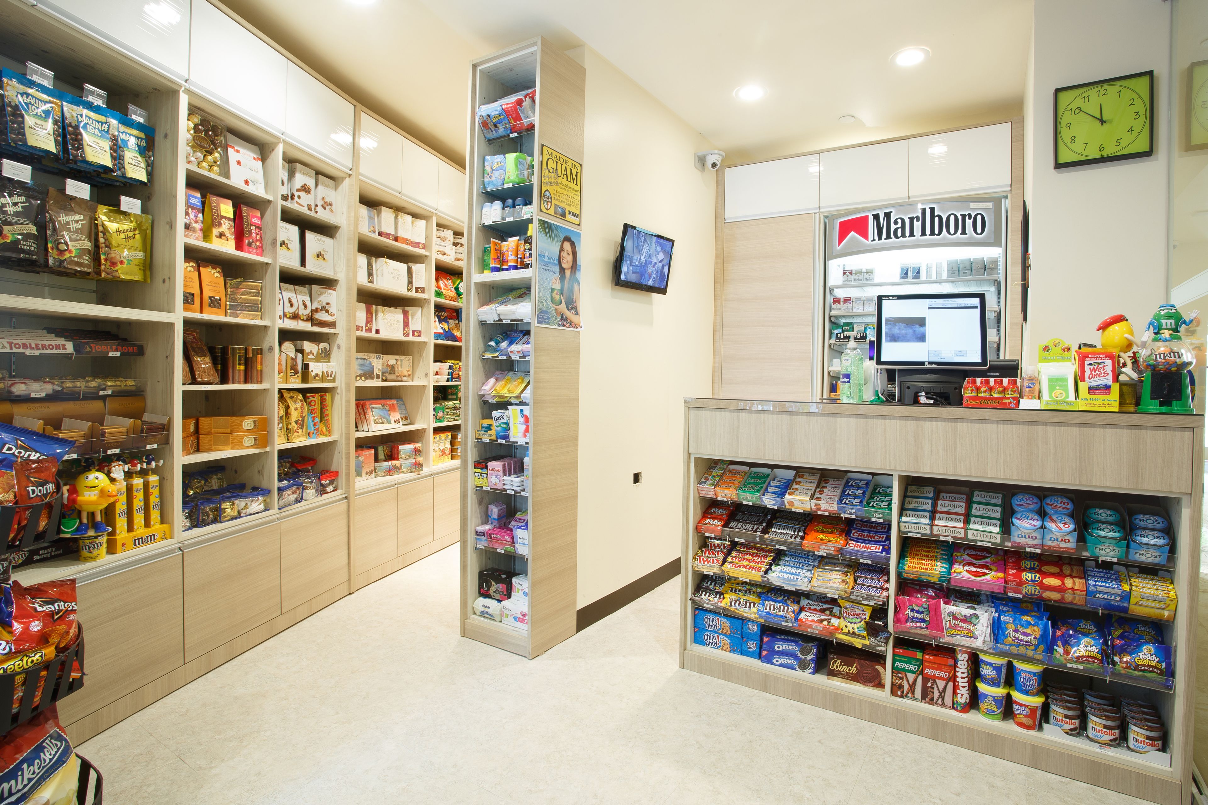 A convenience store with shelves stocked with snacks, beverages, and tobacco products.