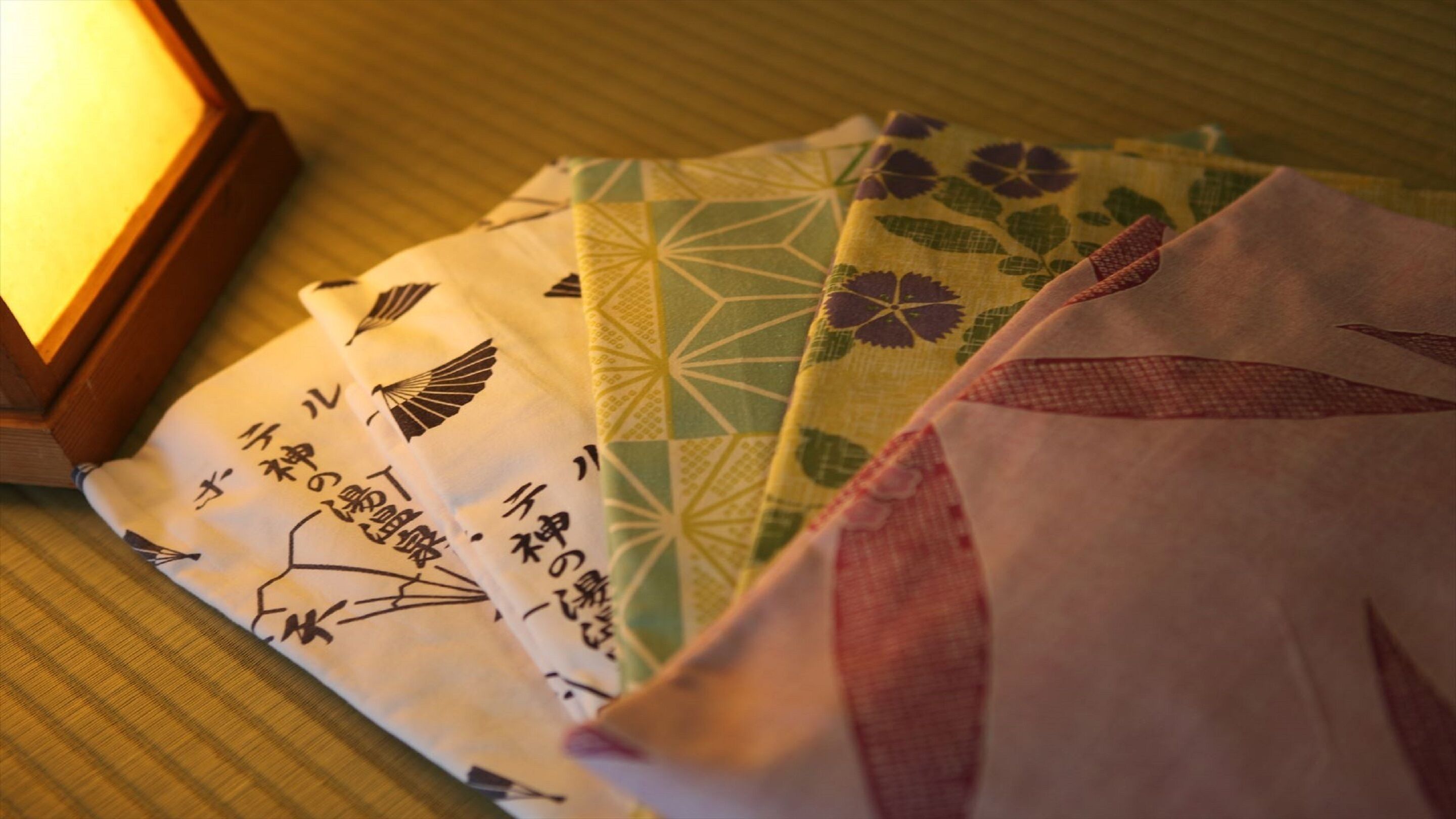 Un conjunto de textiles japoneses tradicionales con patrones geométricos y caligrafía.