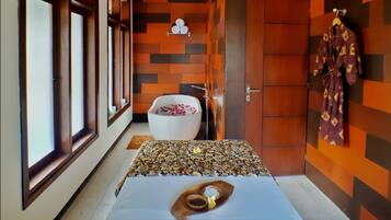 Bathroom features a large window, white bathtub, and geometric tile walls.