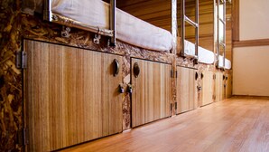 Une rangée de meubles en bois avec des poignées en métal et un matelas posé sur le dessus.