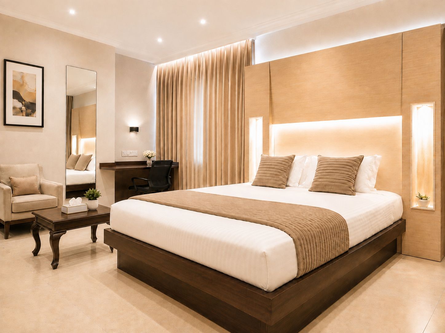 Una habitación de hotel moderna con una cama grande, un escritorio, una silla y un espejo.