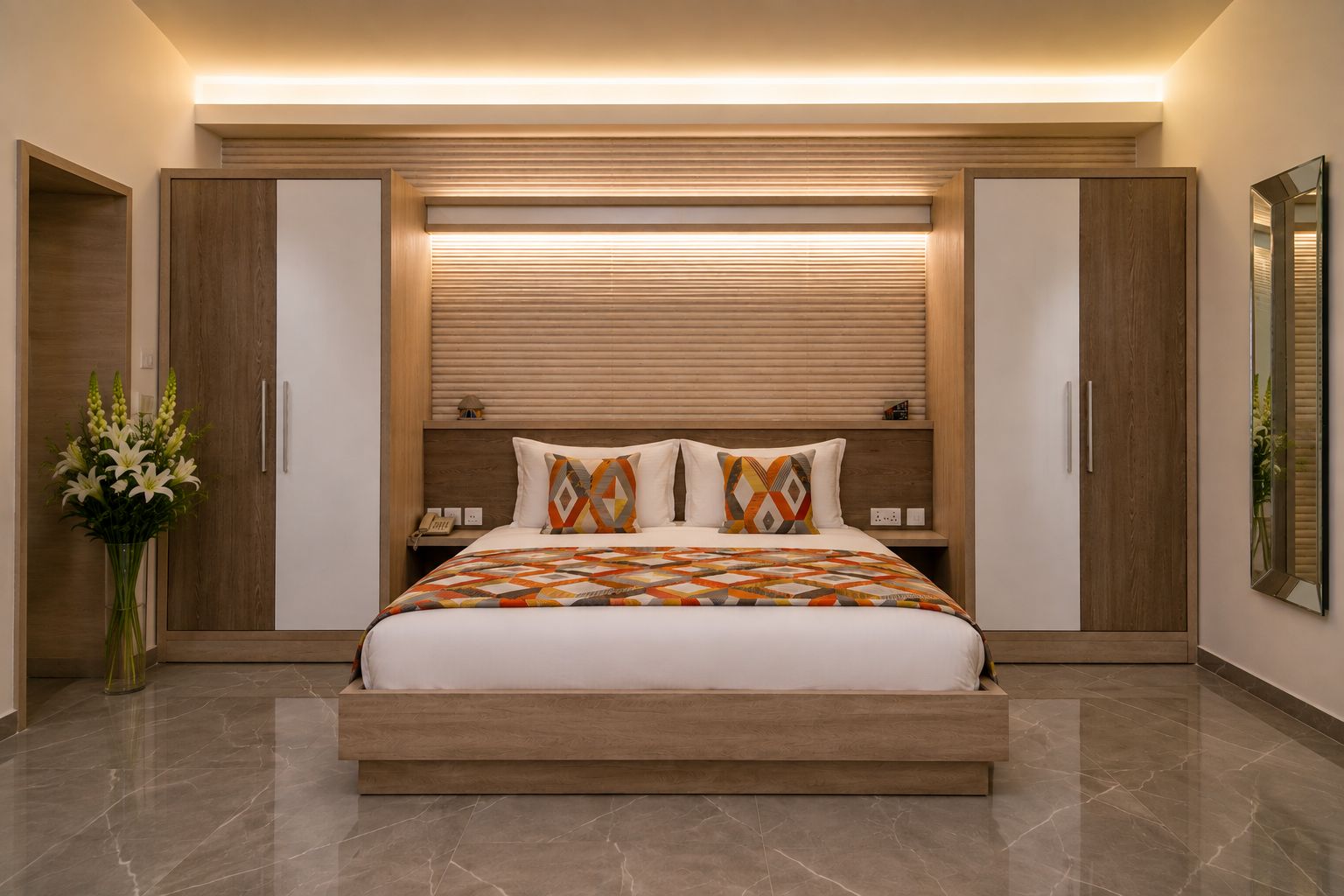 A modern bedroom with a large bed, wooden headboard, bedside tables, and a mirror.