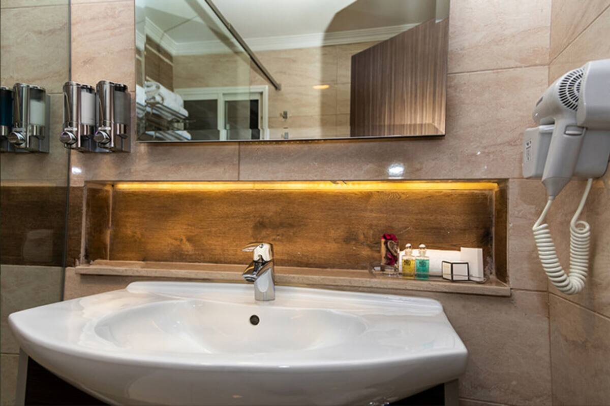 shower, designer toiletries, hair dryer, slippers