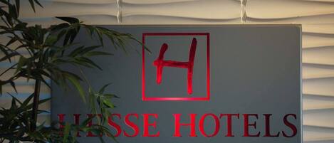 A sign for LIESE HOTELS with a large 'H' in a red square.