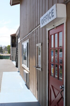 A building with a sign that reads "OFFICE" above a red door.
