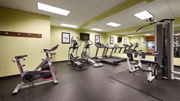 A gym with treadmills, ellipticals, and weight machines.