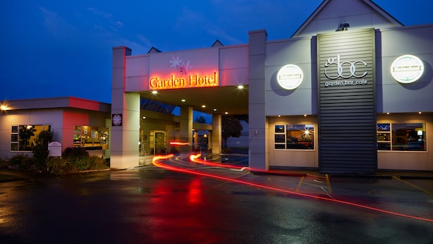 A modern building with a 'Garden Hotel' sign and a 'garden bar cafe' sign. - Garden Hotel Christchurch (Christchurch)